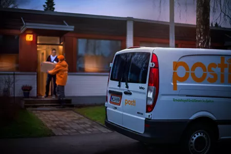 Posti delivering a package to customer's door.