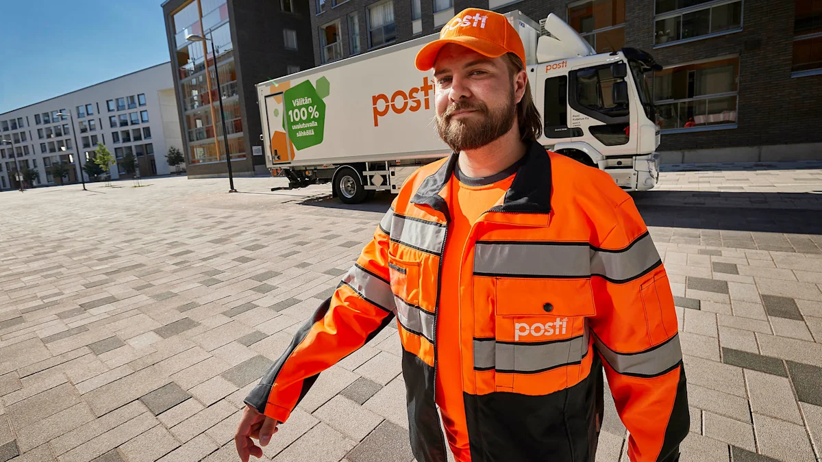 A smiling employee and a postal truck in the background.