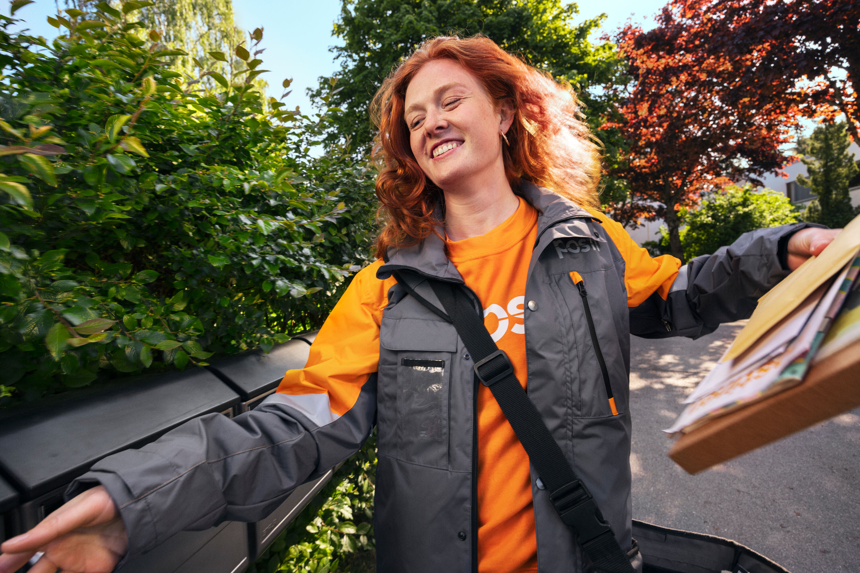 A smiling employee delivering mail.