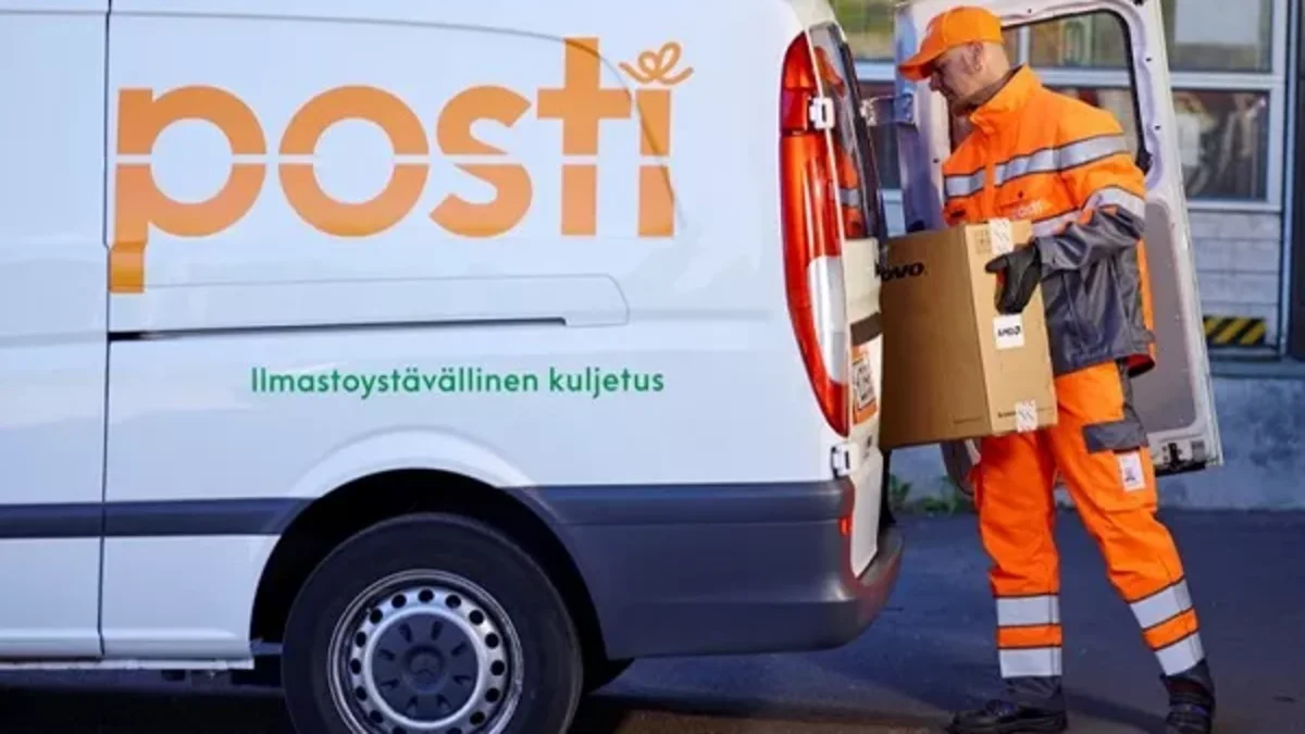 Posti's personnel taking a package out from a van.