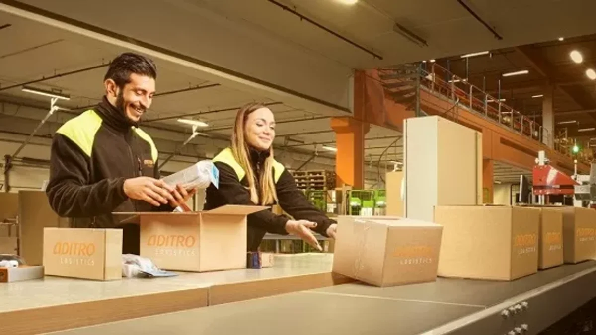 A woman and a man are packing parcels.