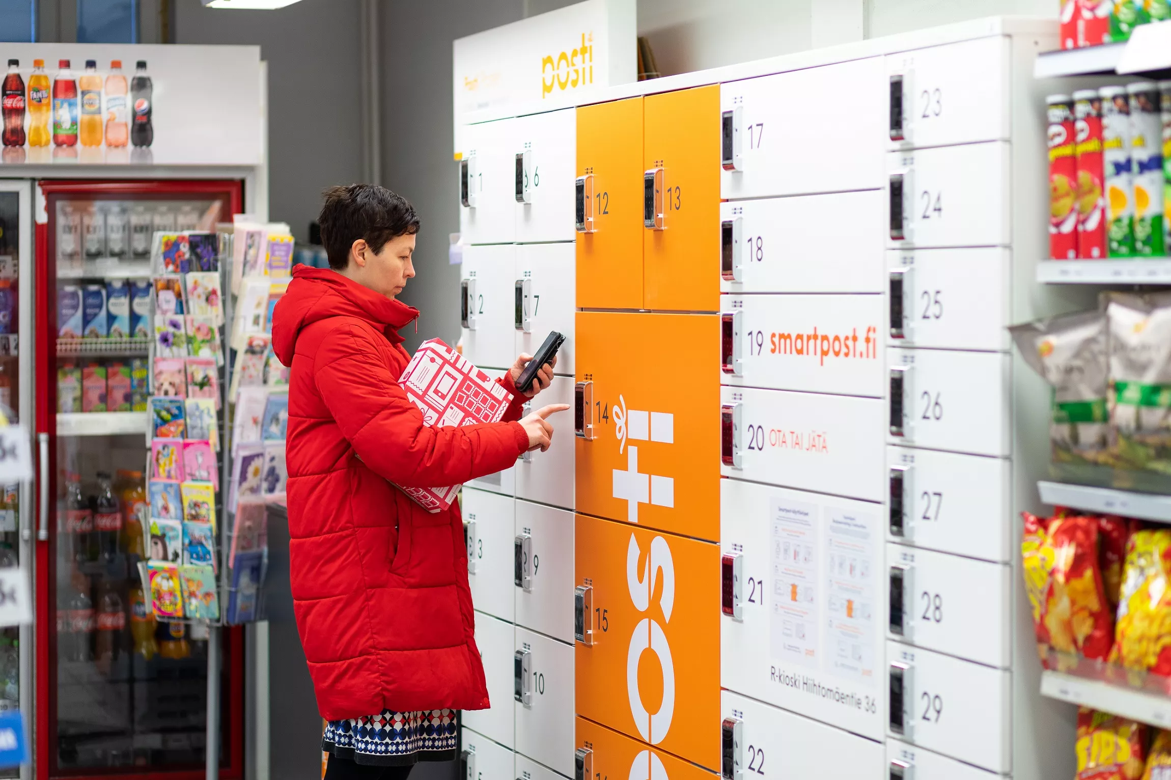 A woman at a parcel locker.