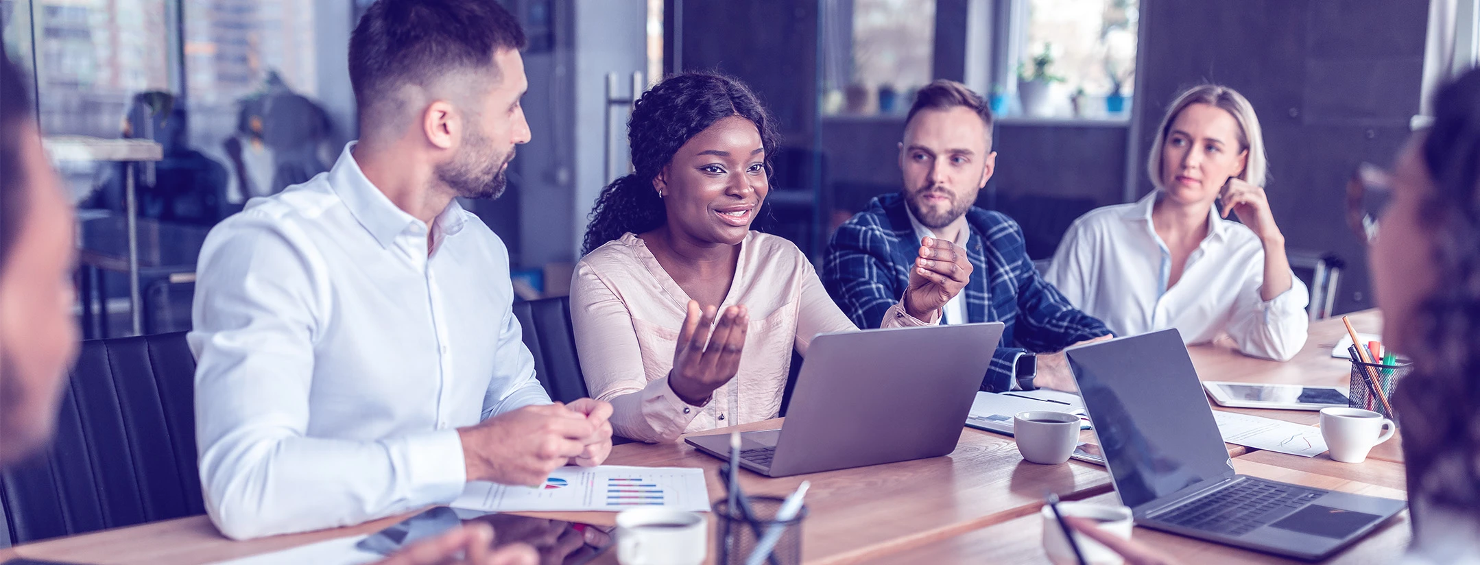 Diverse business team discussing project in a meeting.