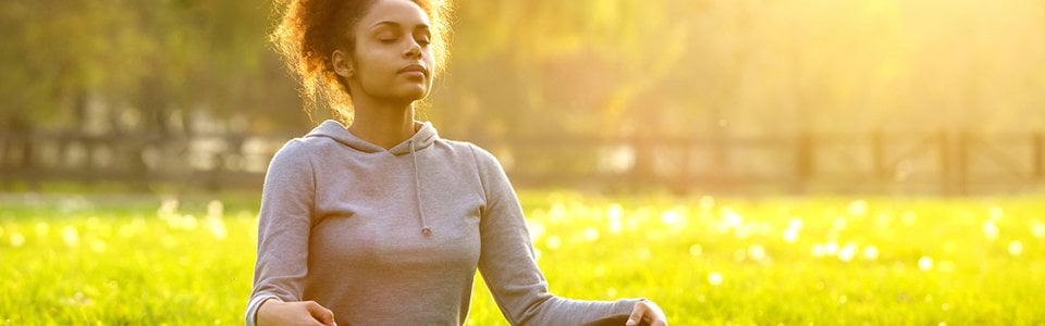 Woman meditating outdoors