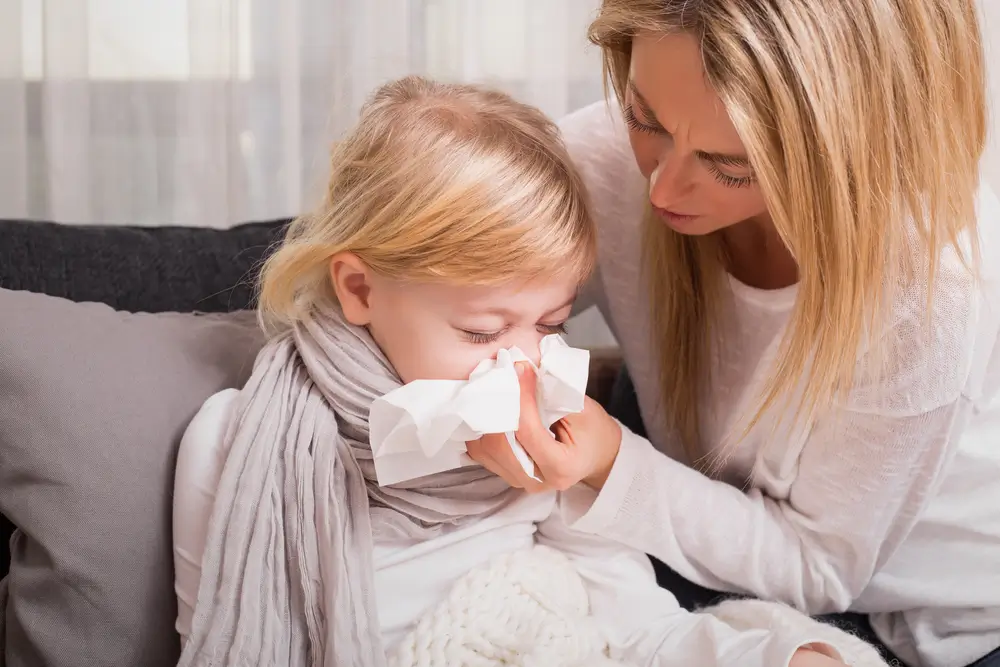 Child Blowing Nose with Mother's Help