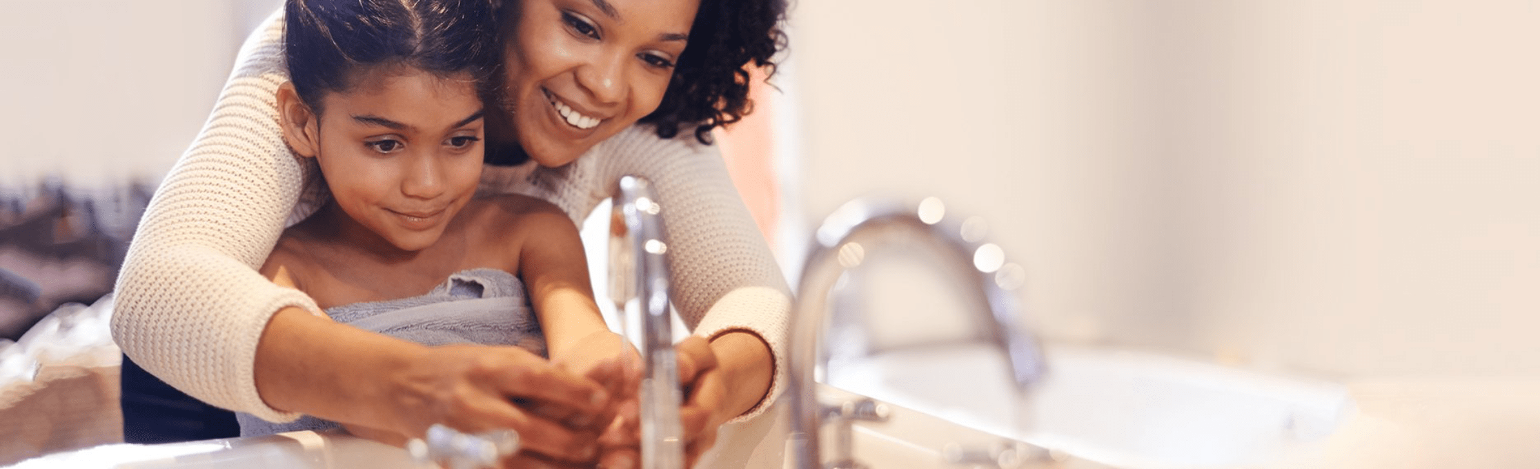 Mother and child washing their hands