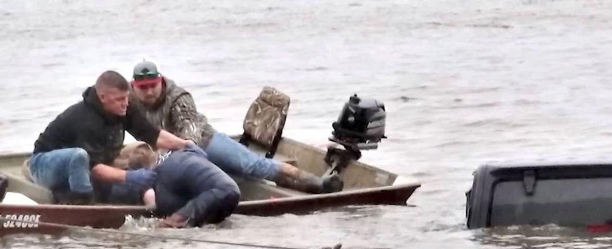 Jeep found submerged in a lake was being dragged out when a live woman was discovered inside. She had been missing for 2 days.