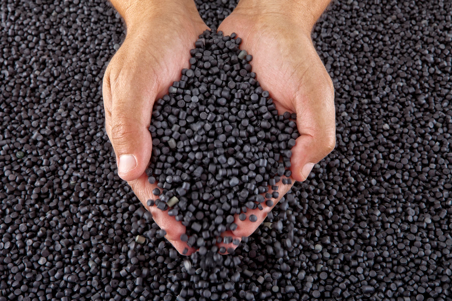 black granules in hand black granules in hand