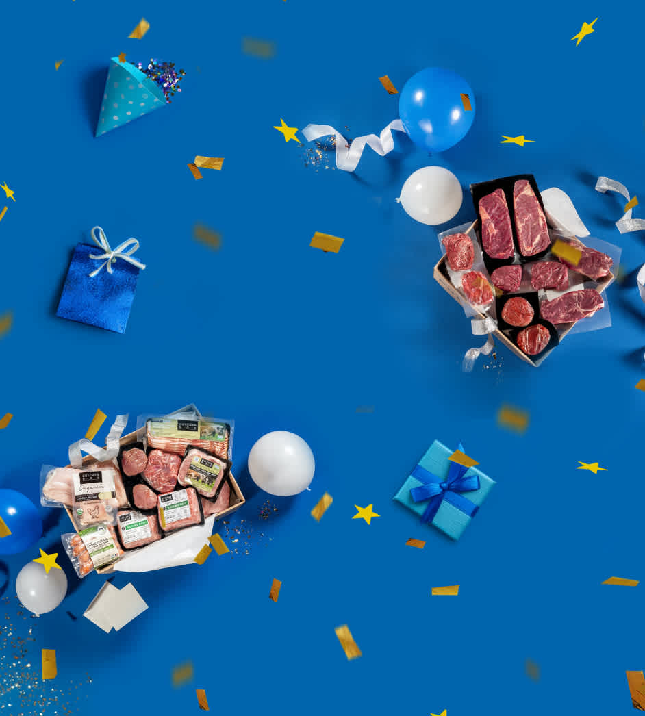 Gift boxes full of meat, seafood, and poultry surrounded by festive balloons and ribbons on a blue background