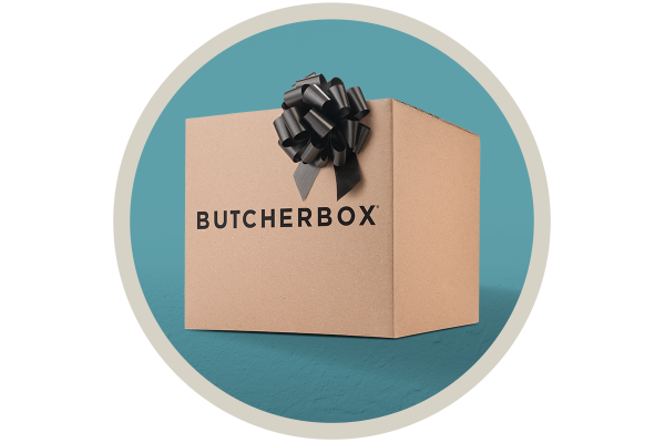 A cardboard box with the butcherbox brand name and black gift bow