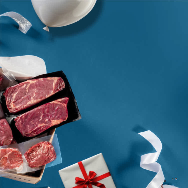 Gift box of high-quality meat on a blue background with balloons and ribbons