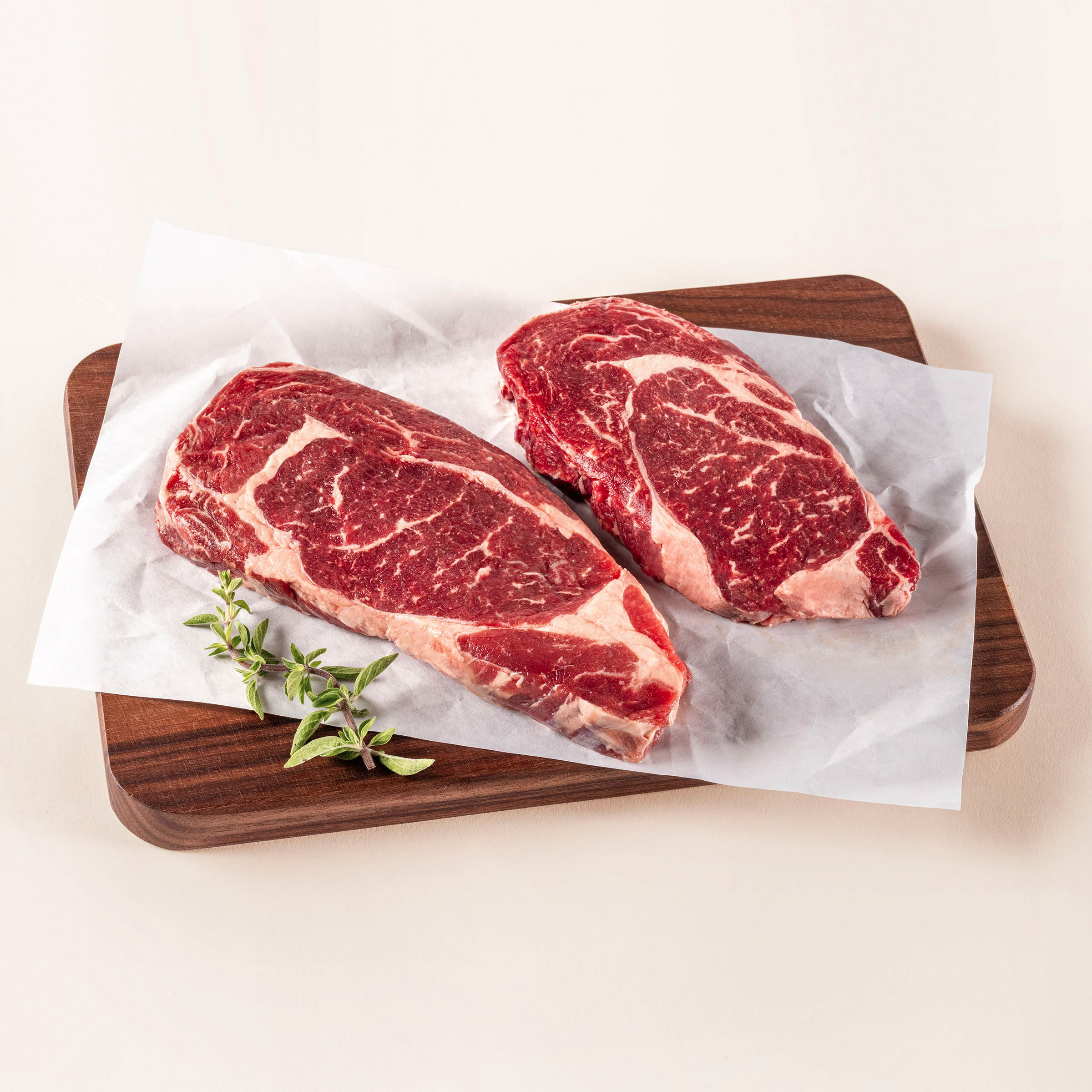 Raw ribeyes on cutting board