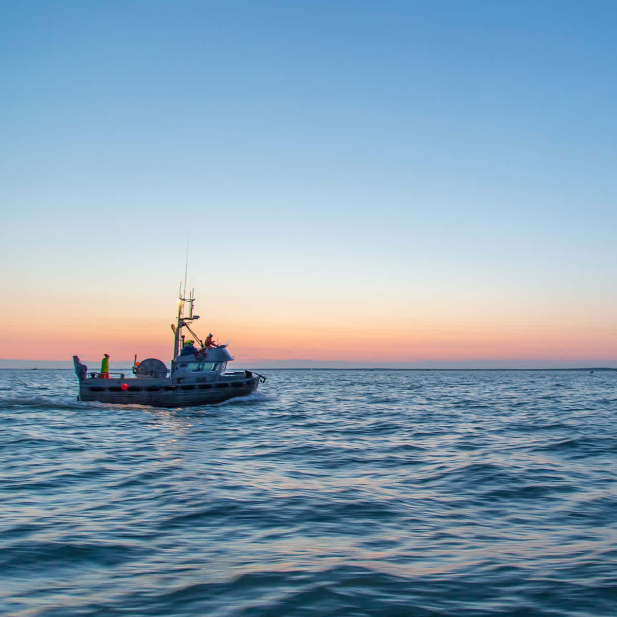 Boat in the ocean at sunset