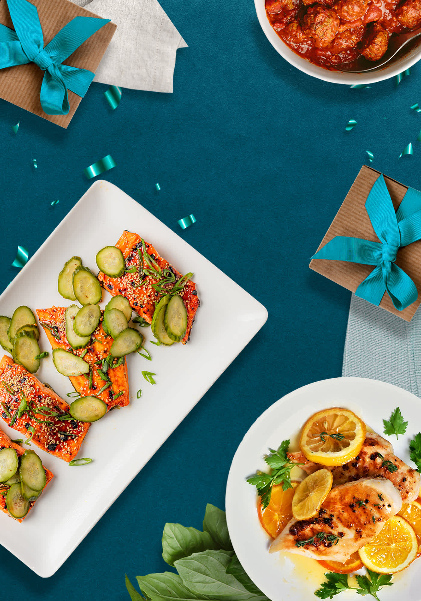 Plated meat and seafood on blue background