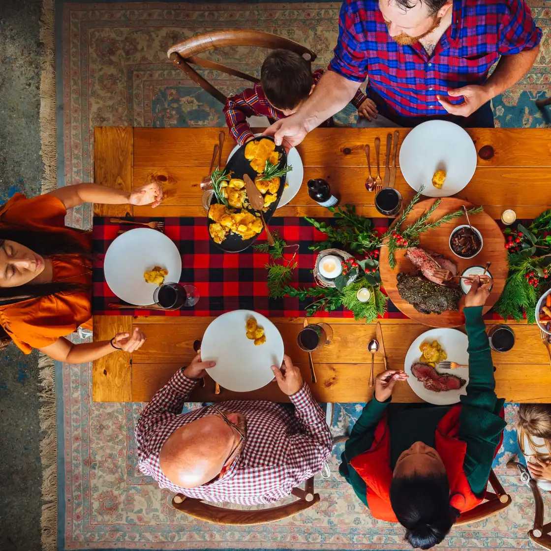 family sitting around thanksgiving dinner table