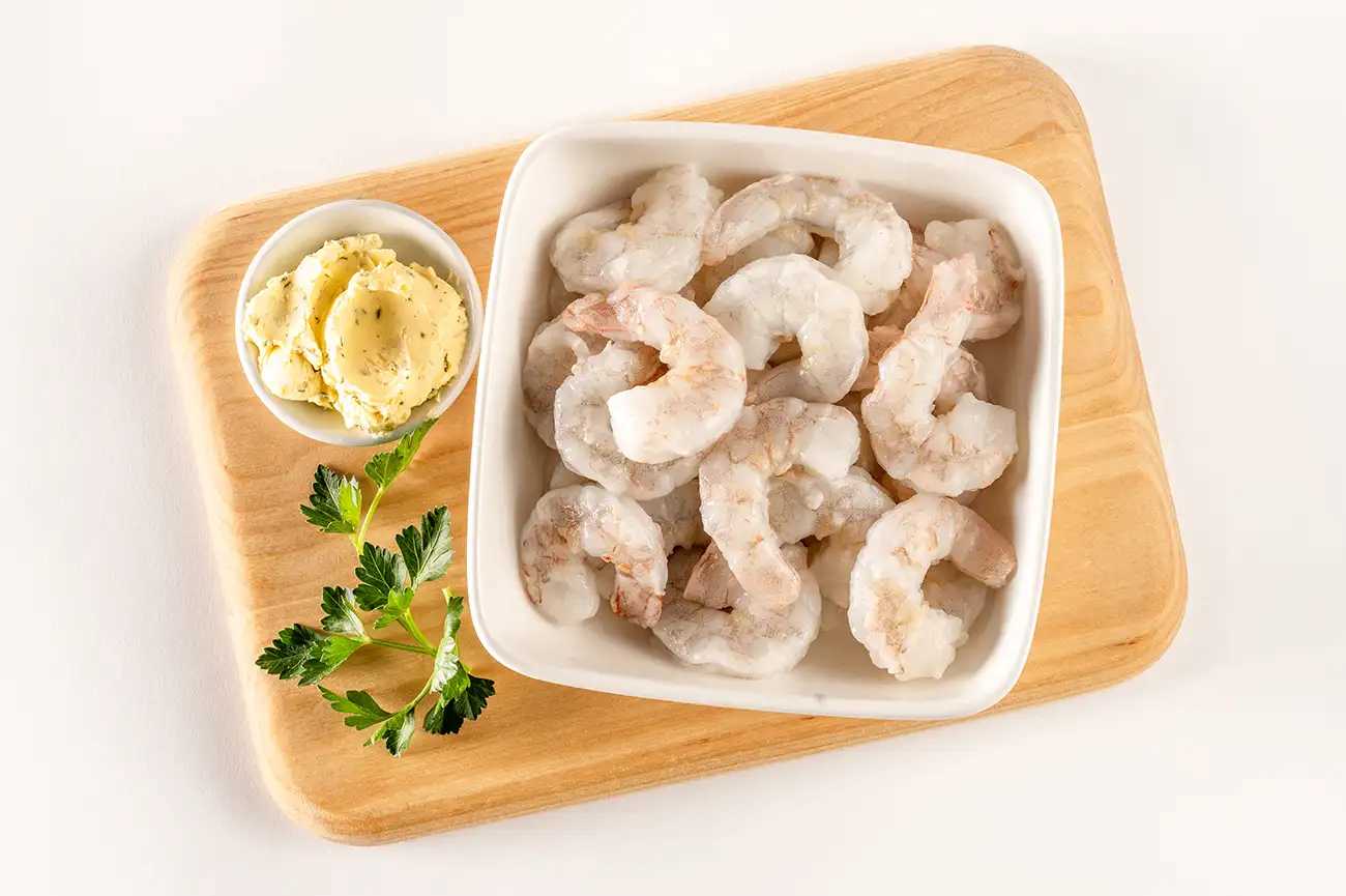 Raw Shrimp in bowl on cutting board