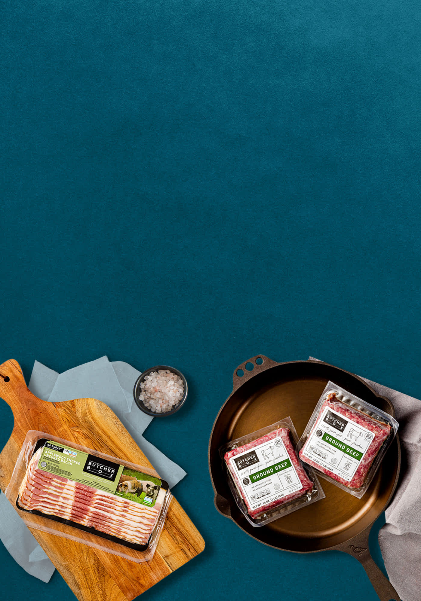 Packaged ground beef and bacon on a blue background