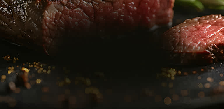 Steak on a grill with gold flakes.