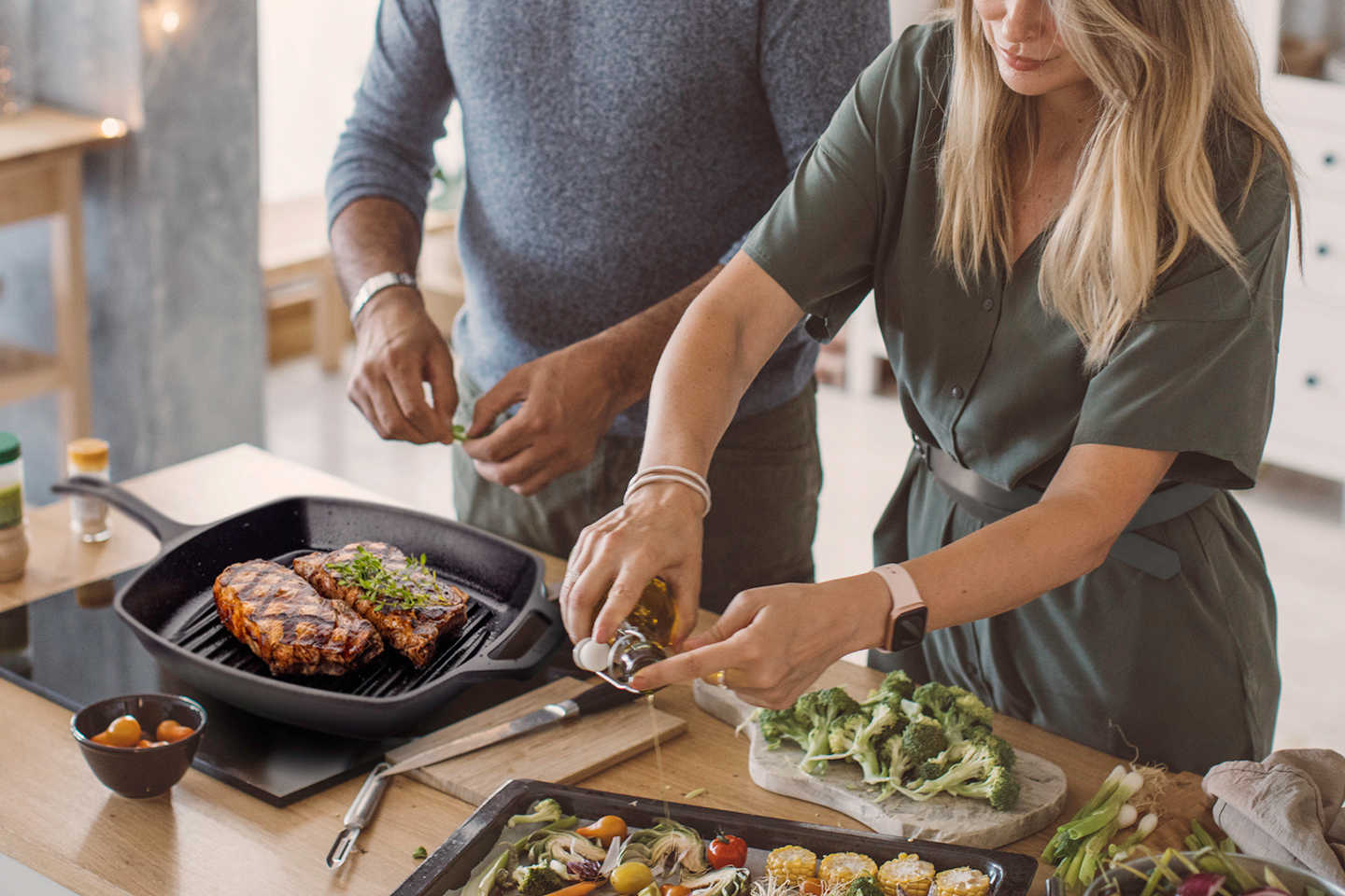 overhead shot of 2 people cooking in the kitchen