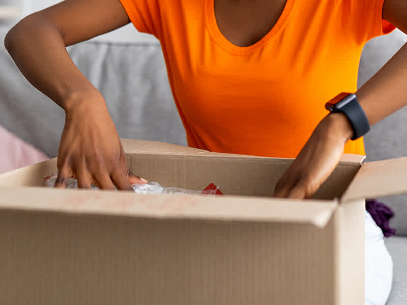 Someone opening up a box.