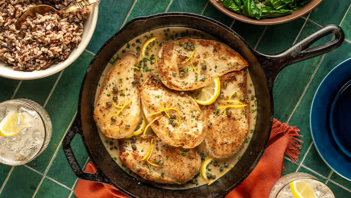 A skillet filled with chicken and rice, a delicious and hearty meal.