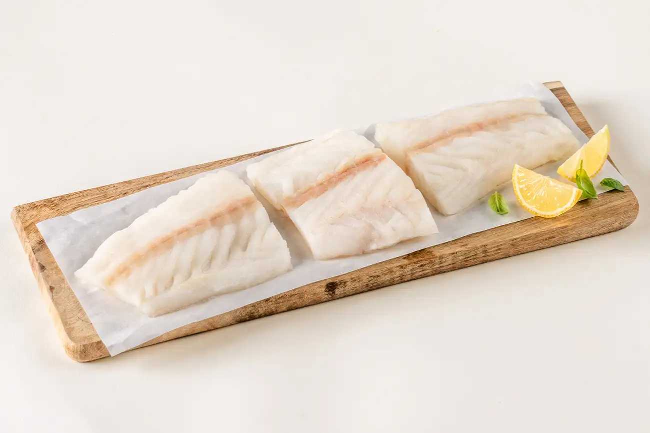 3 pieces of cod on cutting board