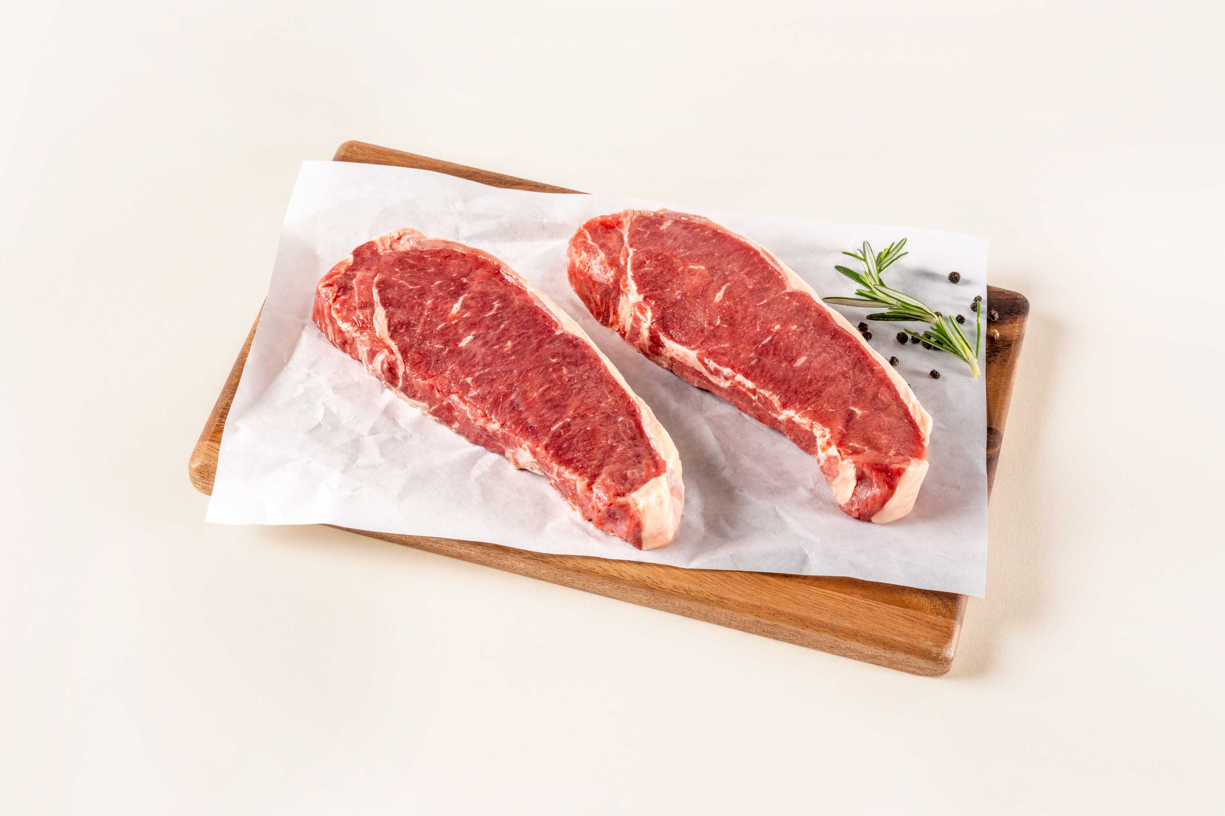 Raw NY Strips on cutting board