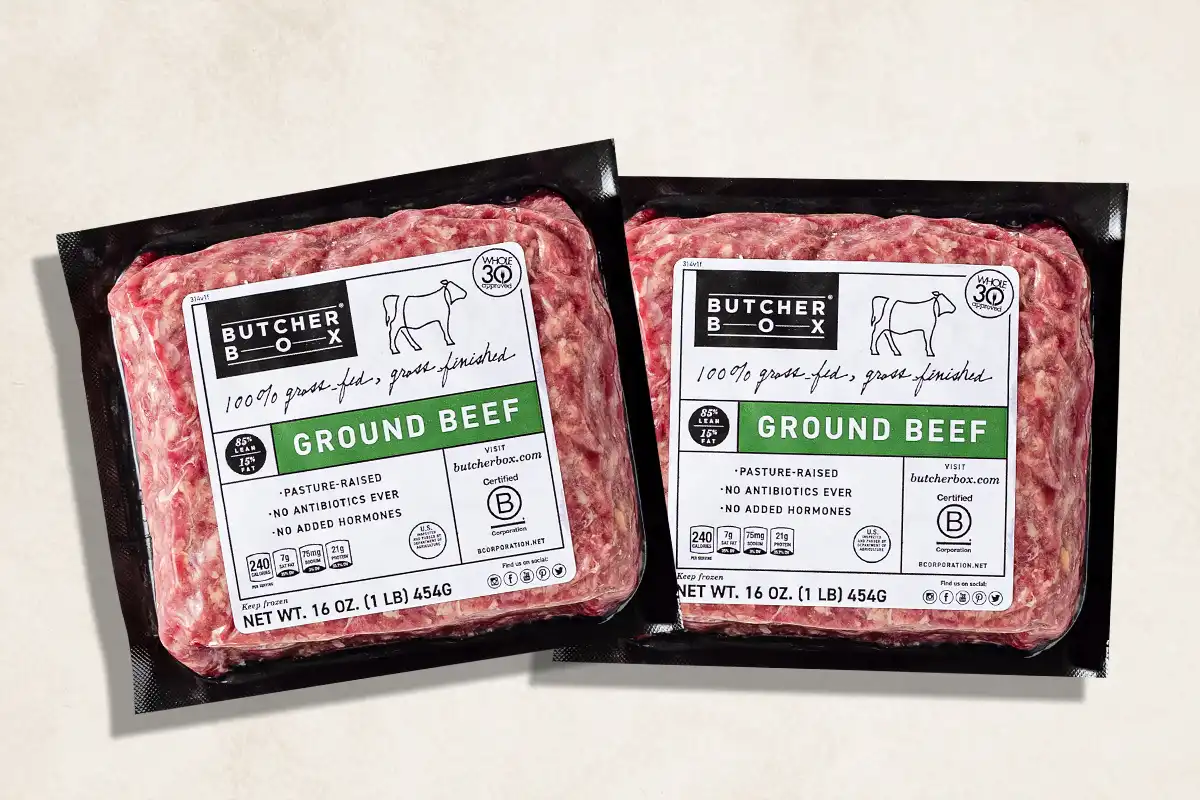 Packaged ground beef on beige background