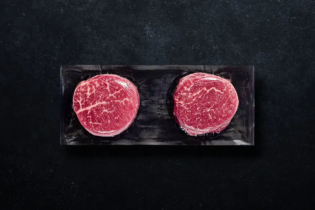 Packaged filet mignon on black background