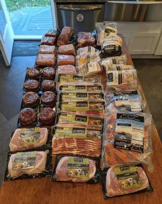 A large quantity of ButcherBox cuts sitting atop a kitchen counter