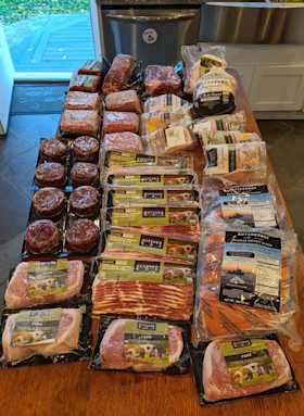 A large quantity of ButcherBox cuts sitting atop a kitchen counter