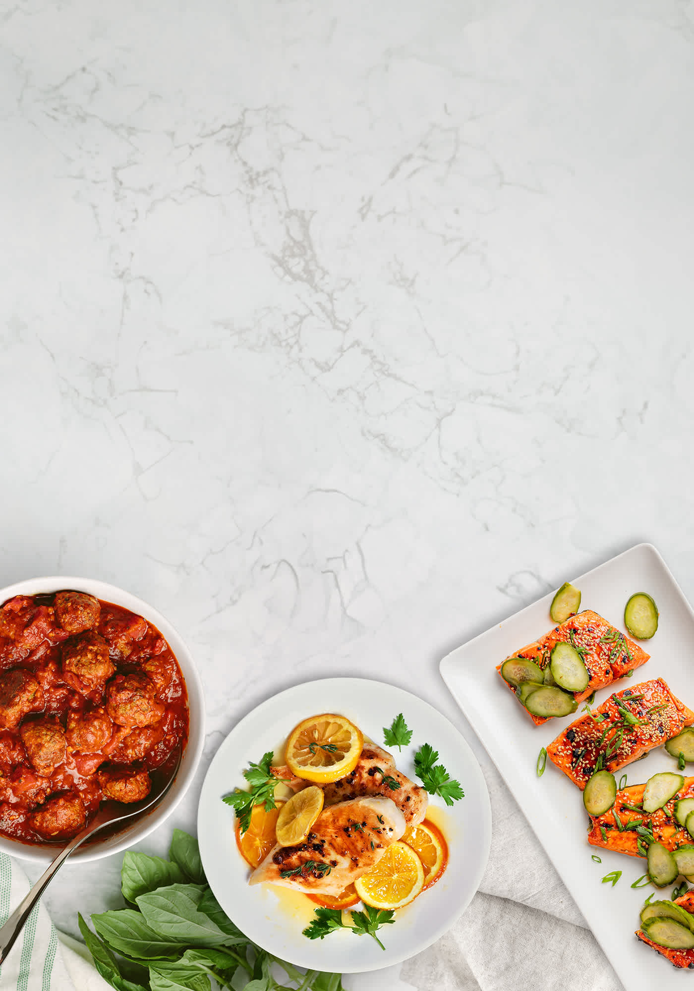 Three plates of food on a marble background
