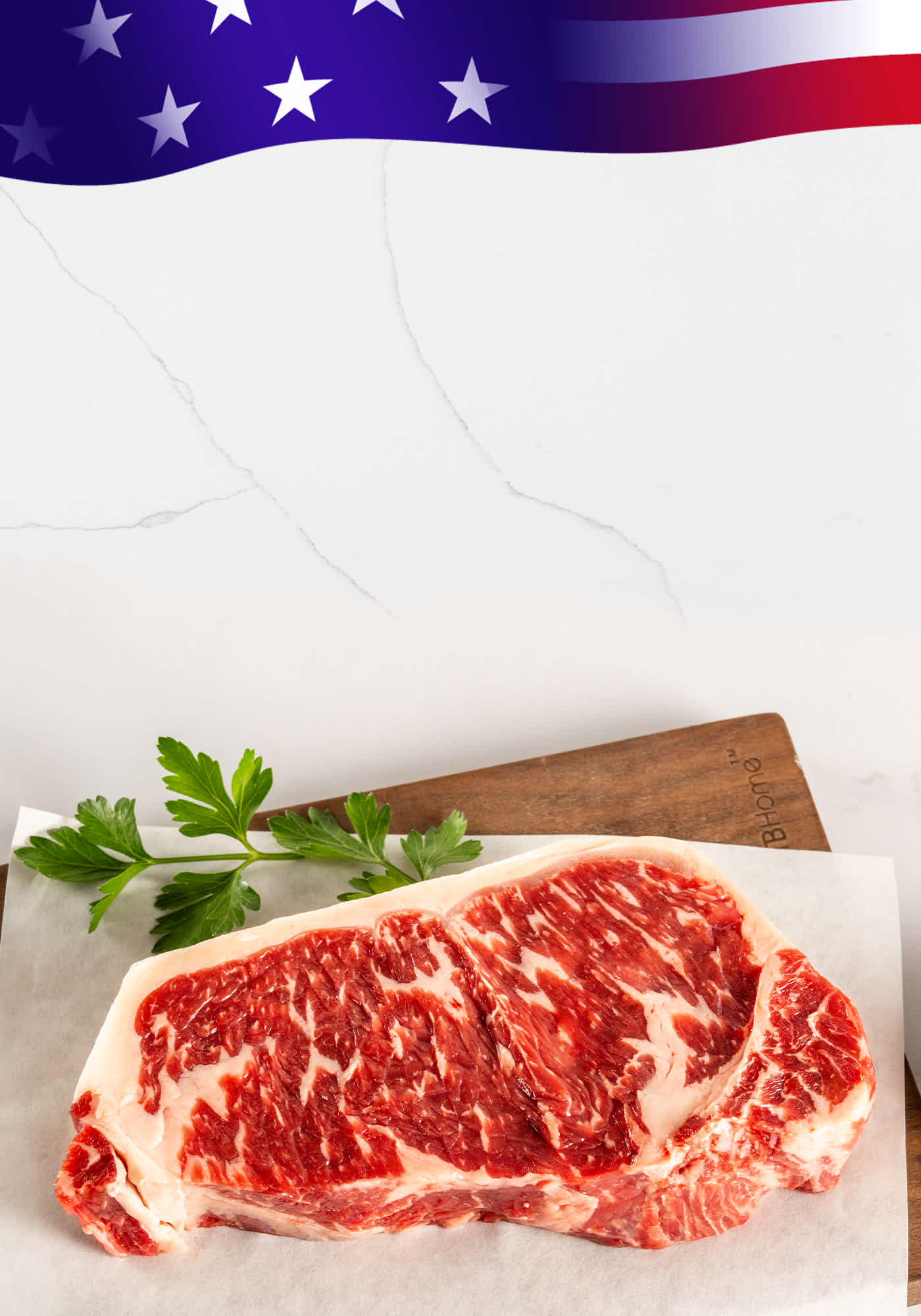 A beautifully marbled ribeye steak on a board with an American flag in the corner