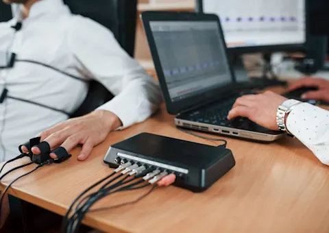 Work in progress. suspicious man passes lie detector in the office. asking questions. polygraph test | Image by Freepik
