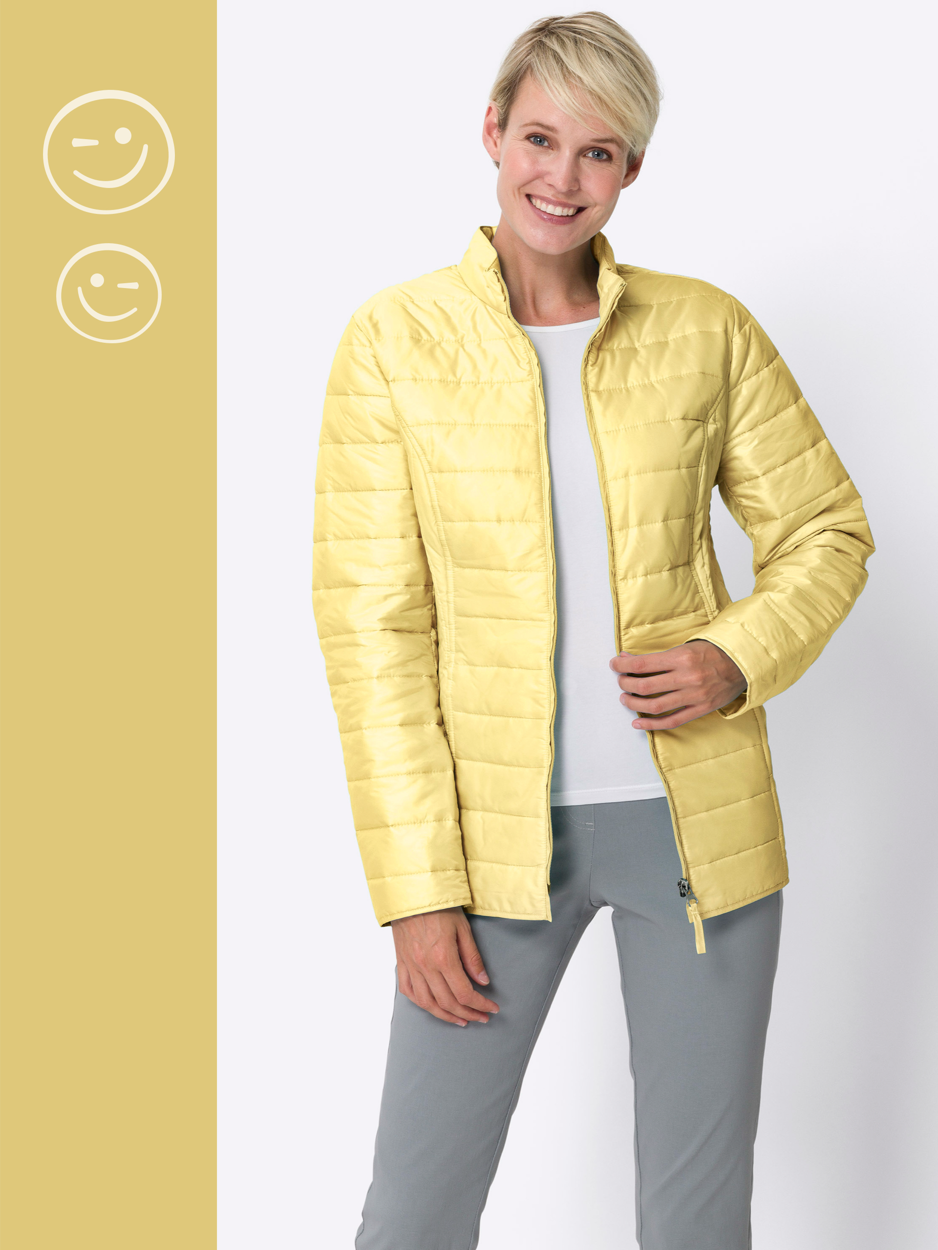 Ein Model trägt eine hellgelbe gesteppte Jacke über weißem Shirt und grauer Hose vor weißem Hintergrund.
