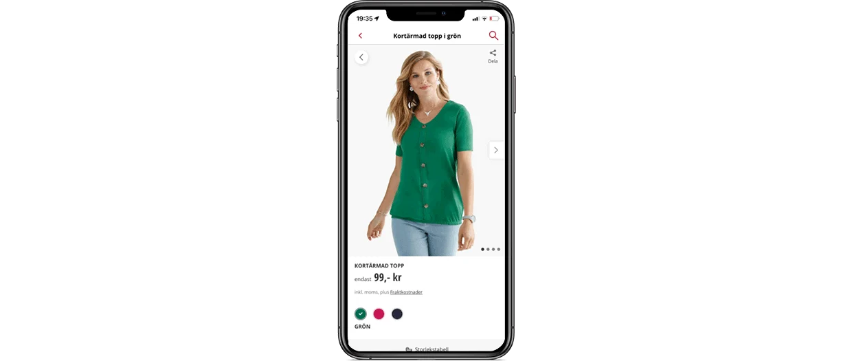 Smartphone-skärm som visar en marinblå blus med vita prickar och prisinformation. Smartphone-skärm som visar en marinblå blus med vita prickar och prisinformation.