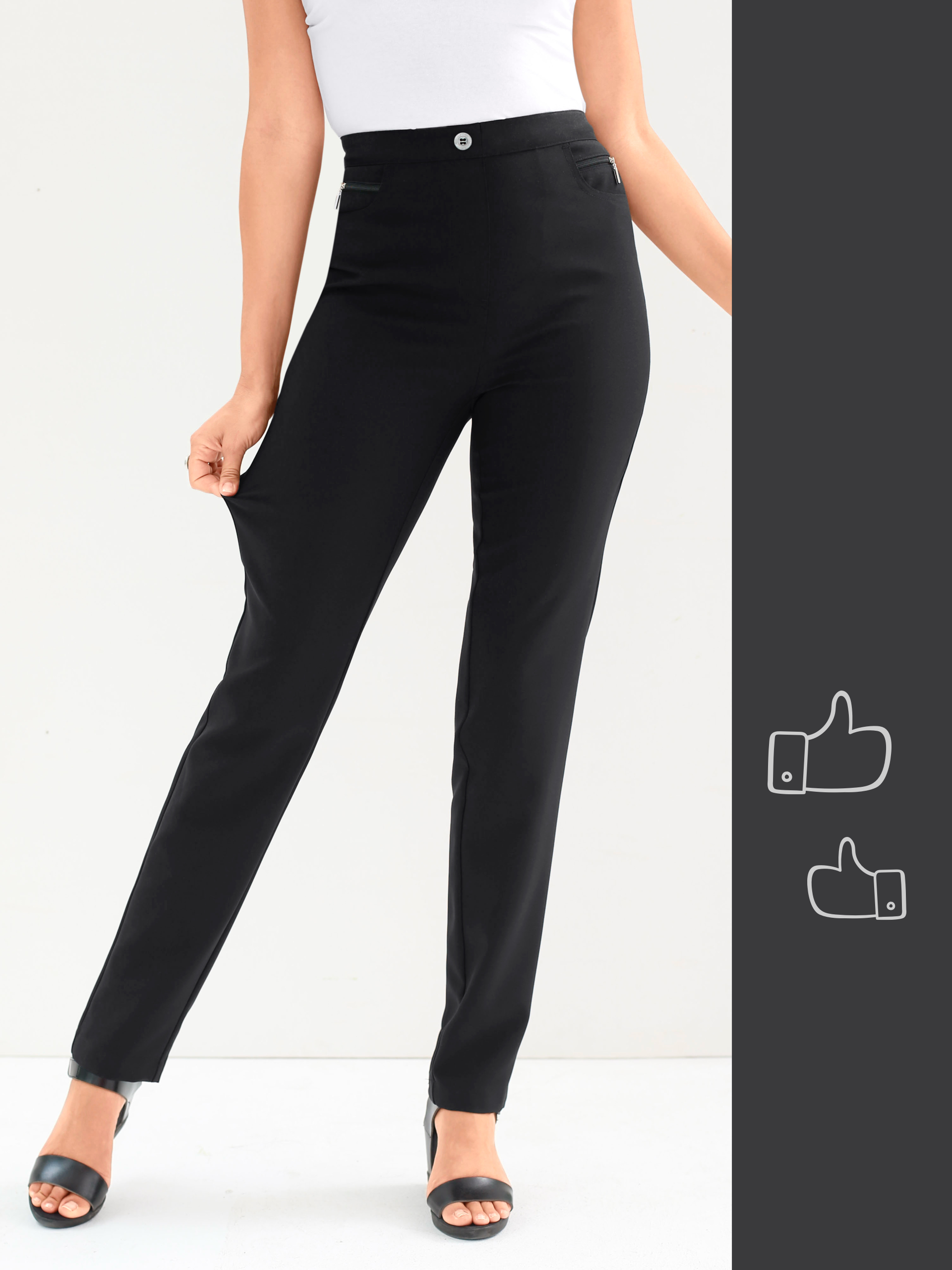 Ein Model trägt enge schwarze Hose und schwarze Sandalen, zieht an der Hose, um die Elastizität zu zeigen.