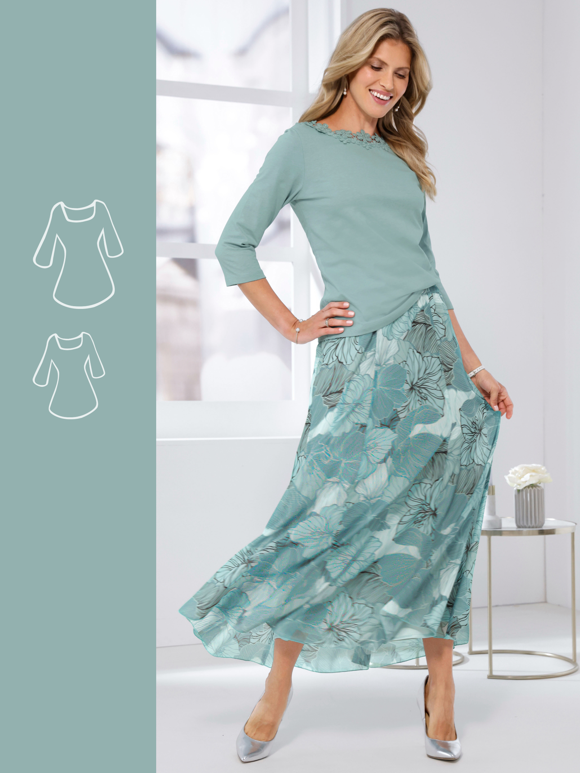 Ein Model trägt ein mintgrünes Oberteil mit 3/4-Ärmeln und einen mintgrünen, gemusterten Maxirock, silberne Schuhe, vor hellem Hintergrund.