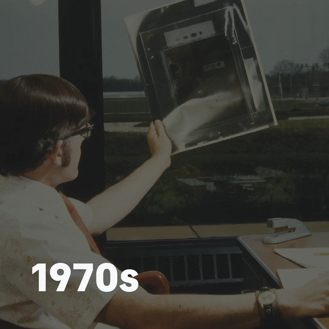 Man viewing prints in the plant 