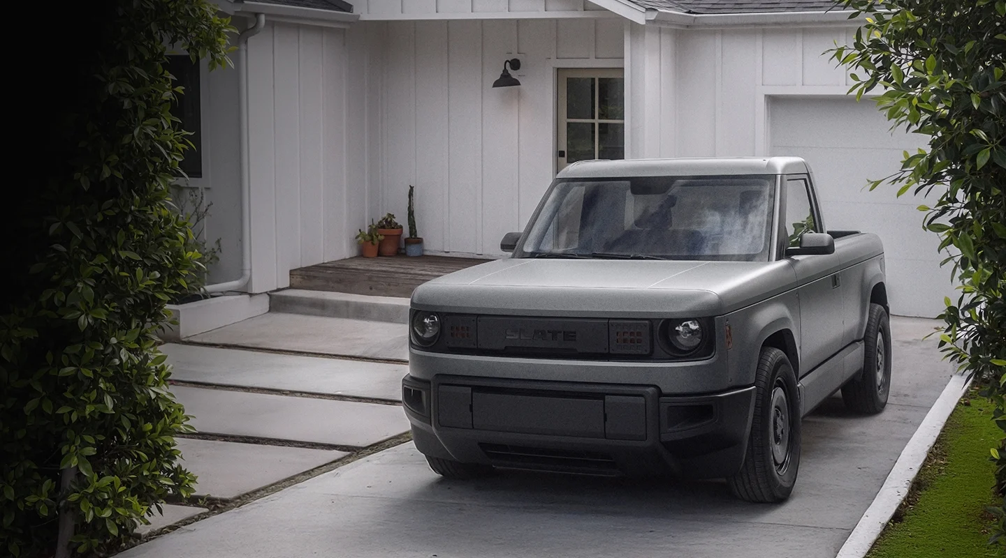 Truck parked in driveway with shrubs