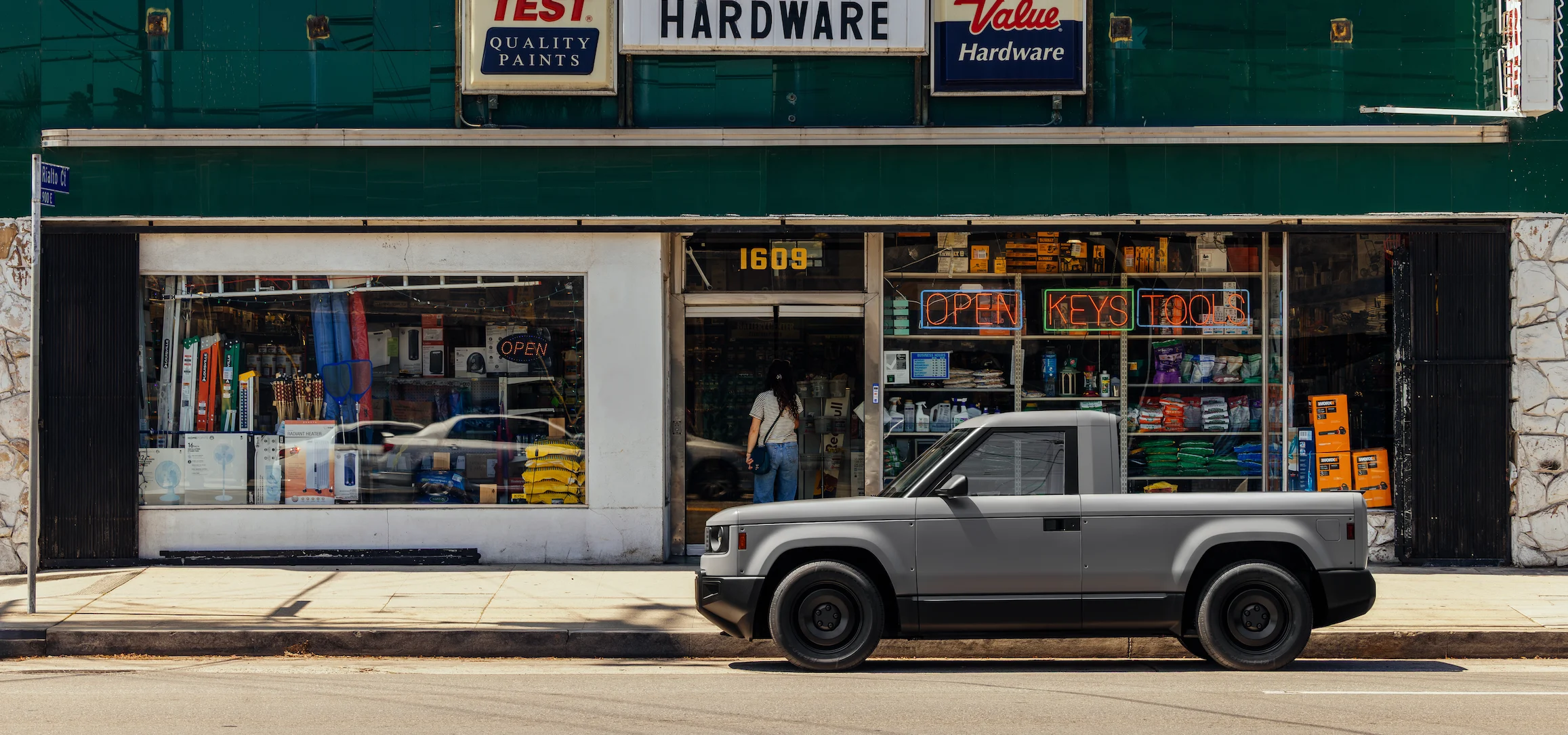 gray blank Slate parked in front of hardware store