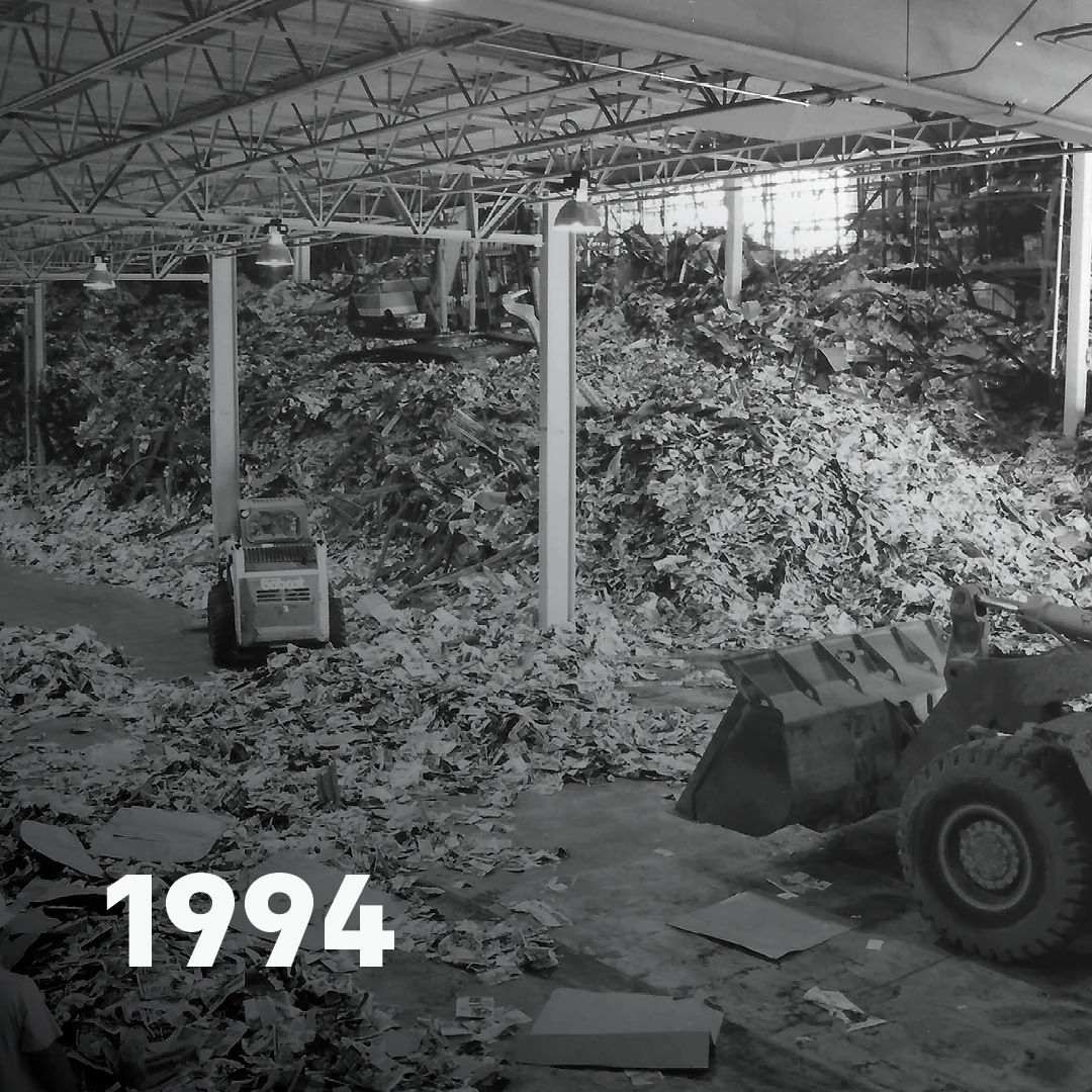 Piles of paper being bulldozed on the factory floor