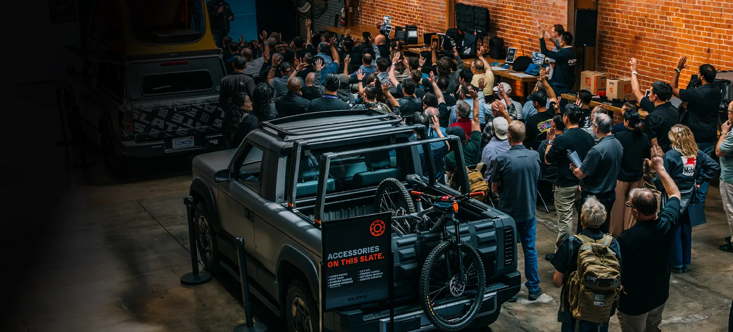 Group of people talking around Slate Truck