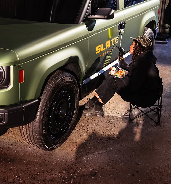 Woman hand painting green truck Detroit