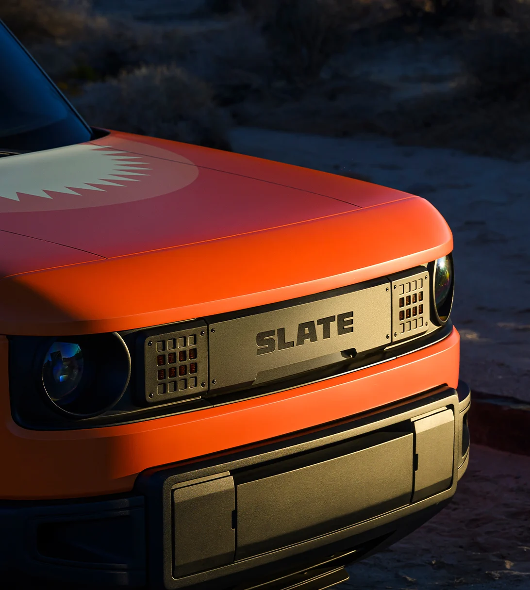 Front of Slate truck in golden hour with orange sunburst wrap.