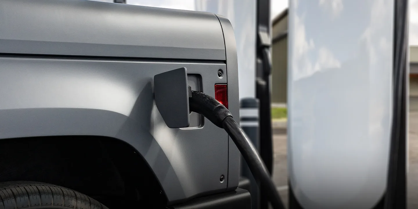 driver charging Slate truck at supercharger