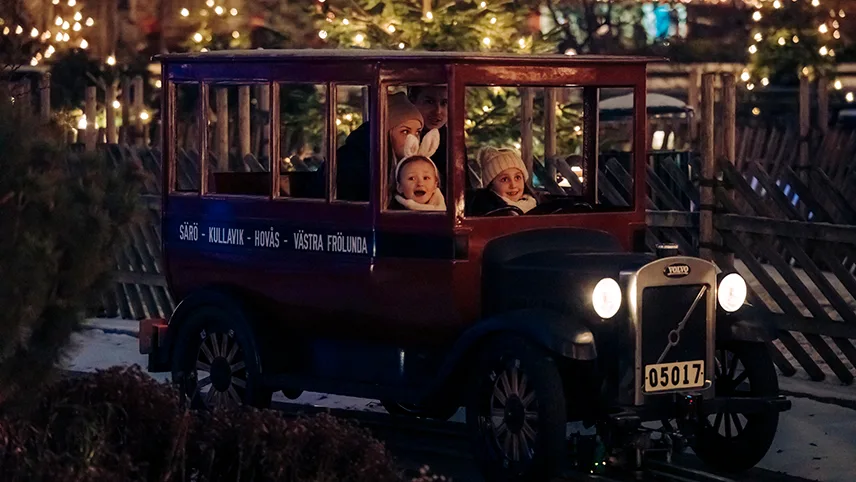 Farfars bil i Liseberg ved juletid med en glad familie i vognen.