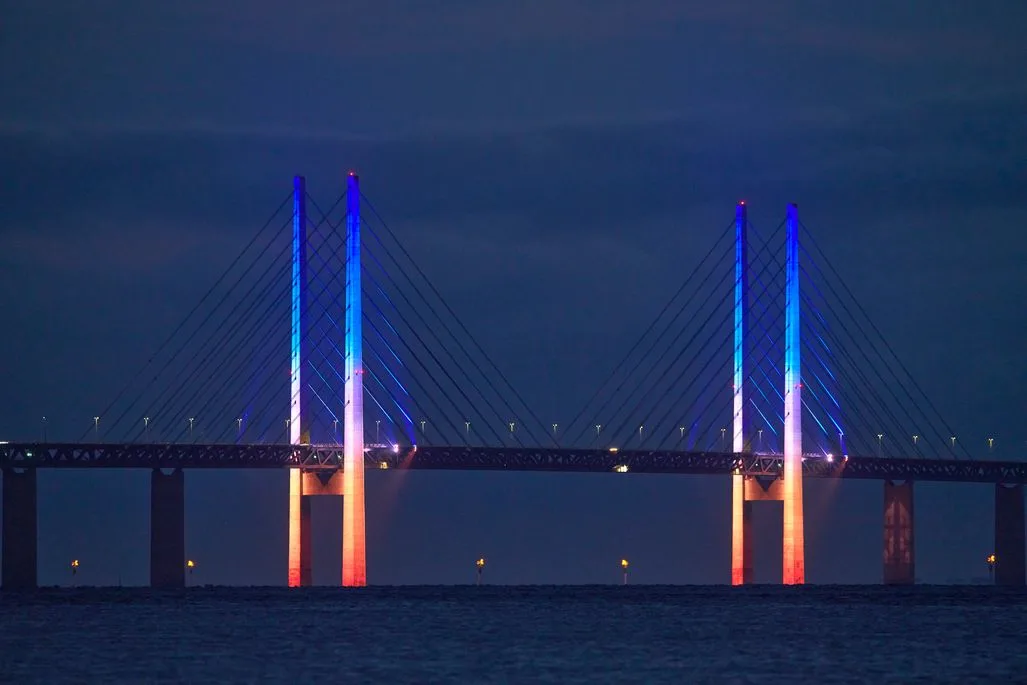 Øresundsbron is illuminated every evening in changing colors during the Copenhagen Light Festival