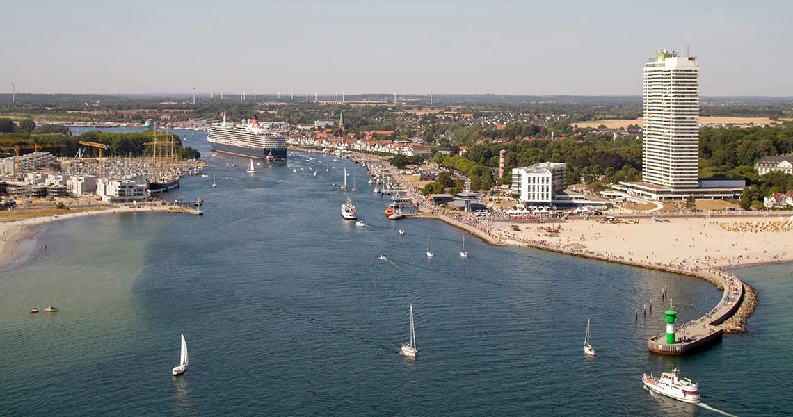 Flygfoto över Travemünde med strand, hamn, segelbåtar och höghus vid kusten