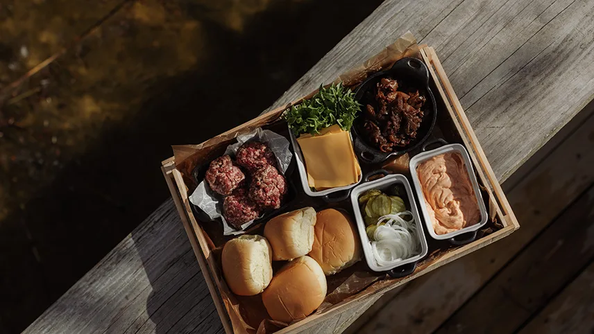 Aftensmadsmuligheden hos Yggdrasil Igloo i Skåne, hvor man kan forbestille en pakke med burger. Her ses alt indhold til burger.